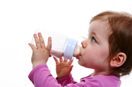 Baby with bottle of organic natural formula breastfeeding nursing is best