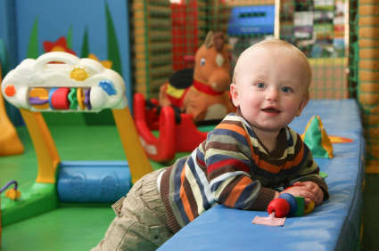 baby playing in green organic natural nursery decorating