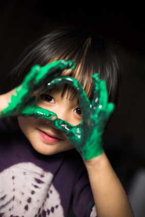 child playing with all natural non-toxic paint