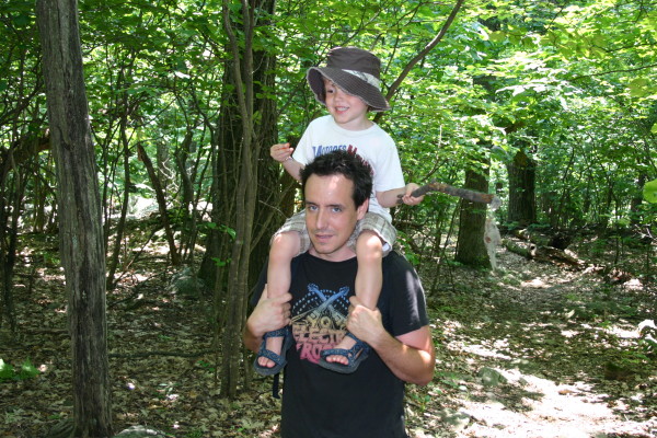 father and son hiking in the woods nature outdoors